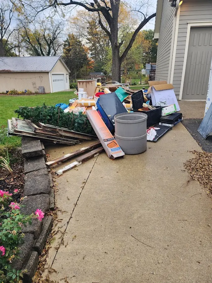 Dumpster being loaded with debris for Roofing Dumpster Rental in Newton Falls